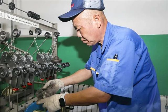 装备制造集团唐村实业公司电缆制造车间，束线工邢宝磊以匠心操控设备精准生产采煤机电缆控制线，汗水浸透衣衫挂满脸颊，他仍用毫米级精度打磨每道工序，在滚烫生产线谱写新时代劳动者的奋进乐章。（唐斐）.jpg